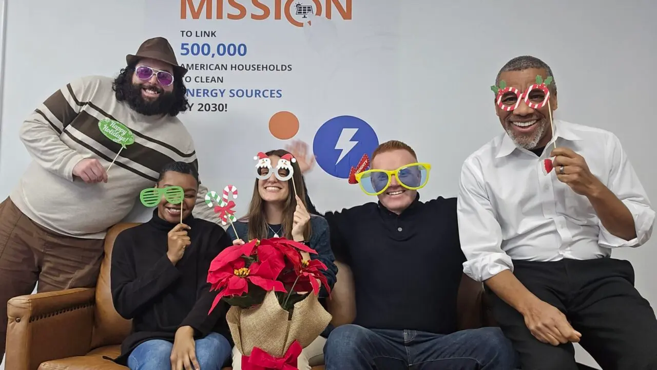 Finray Solar employees in front of our Mission wall